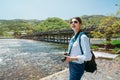 Elegant traveler standing next to the clean river